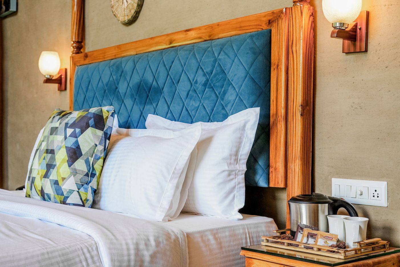 Teal upholstered king bed with premium linens