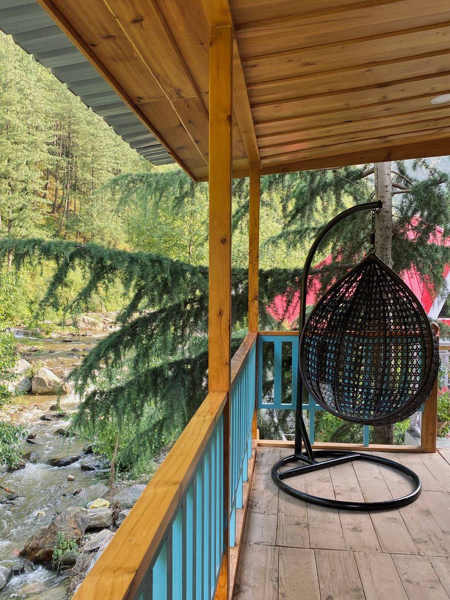Hanging chair on the balcony above the river