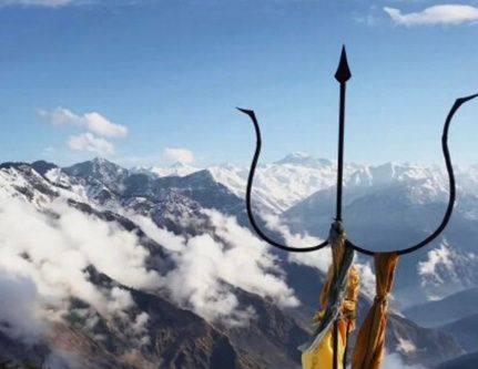 Trident at Bijli Mahadev temple above snow peaks and clouds