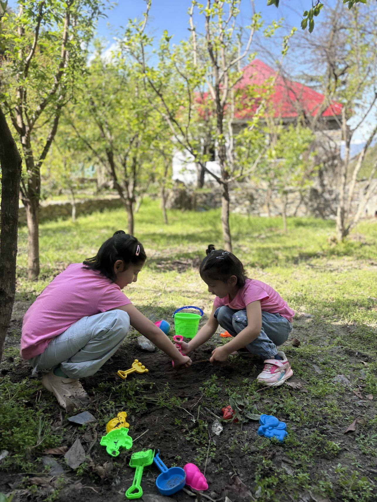 Children gardening under fruit trees