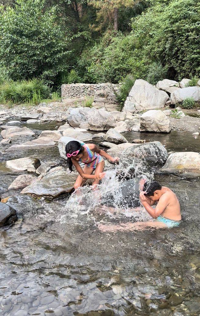 Kids splashing in the shallow river