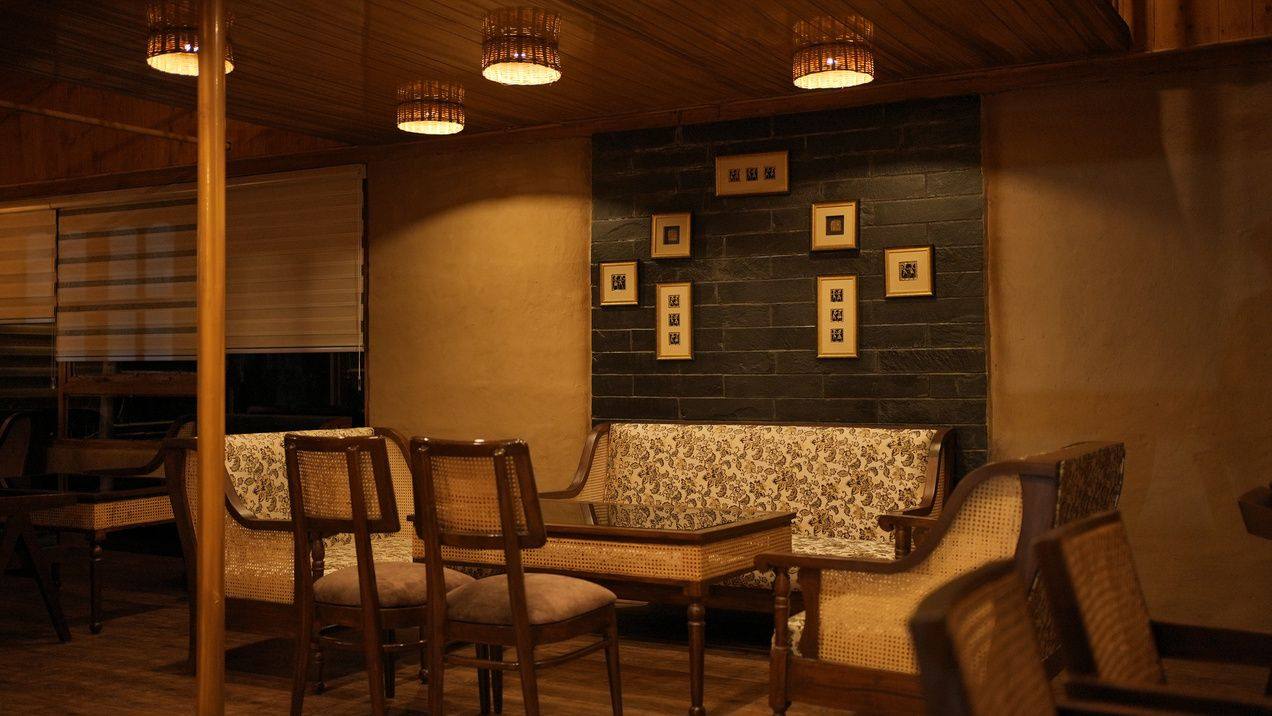 Mud Kathkuni Restro dining room with warm lamps and timber ceiling