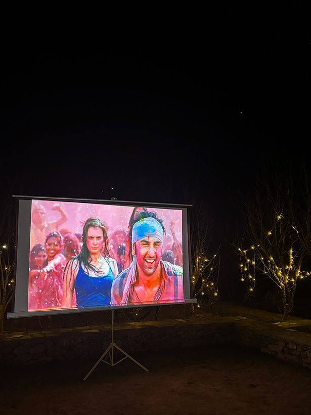 Projector screen under string lights at night