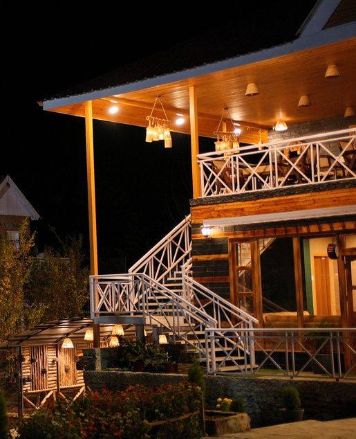 Lantern-lit wooden terrace and staircase at night