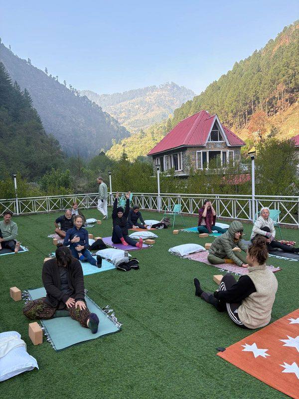 Guests practising yoga on the lawn